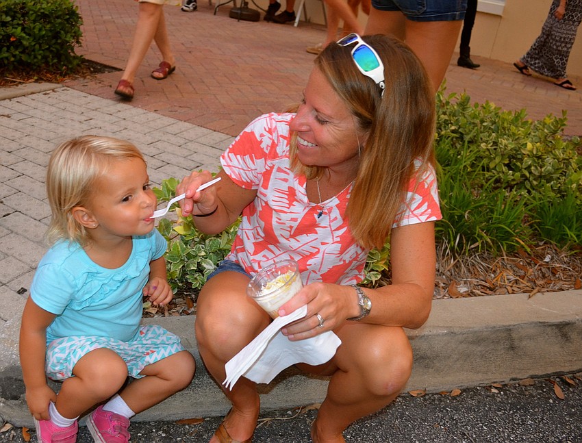Riley Irwin snacks on ice cream her mother, Angela, feeds to her.
