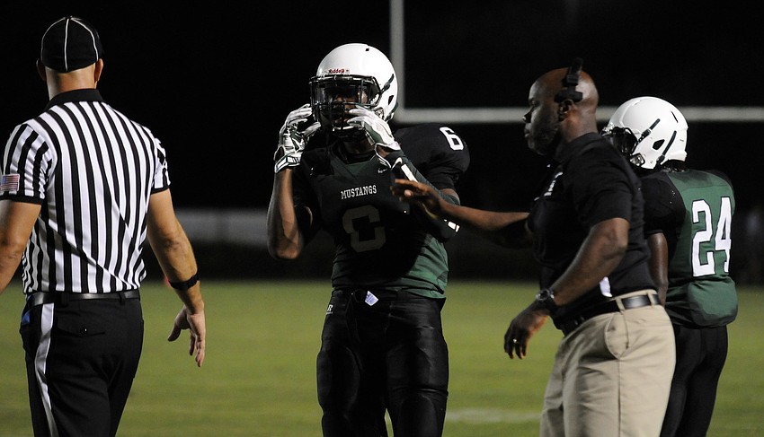 Lakewood Ranch defensive back Daymon Murray receives the play from defensive coordinator Carlton Hadley, Jr.
