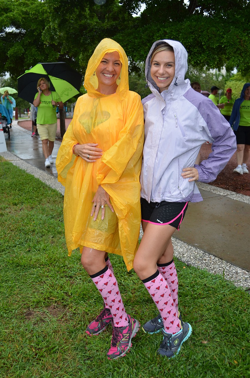 Rebecca Davis and Patricia Harmes take a moment to show off their heart-themed socks.