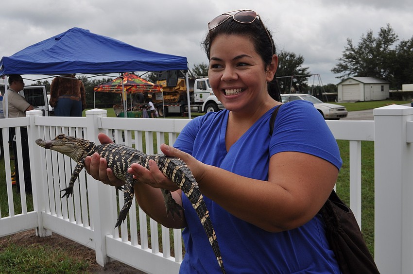 Thalita Fuschetto holds an alligator for the first time.