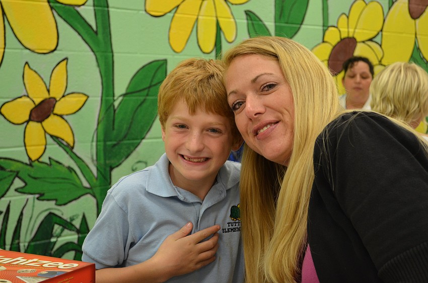 Isaiah, 8, and his mother Erica Wade sat down for dinner and to play a game of Yahtzee.