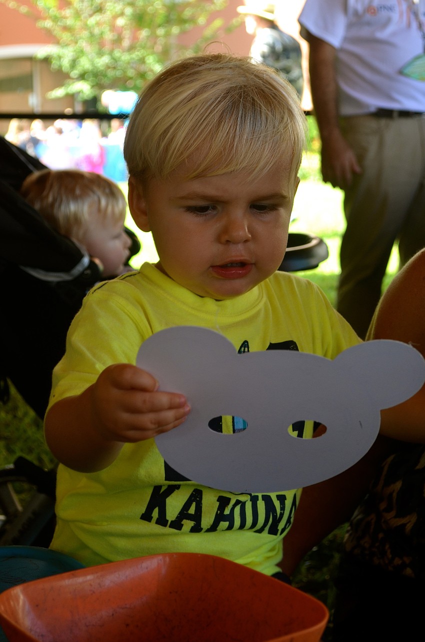 Two-year-old Ben Hill admires his new mask.