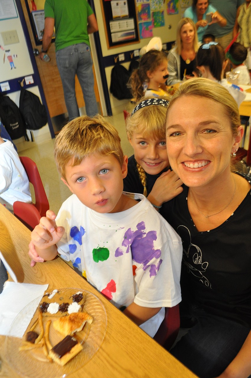 Ethan, Erin and Taryn Eddy feast on Parisâ€™ French fries, crescents and other treats.