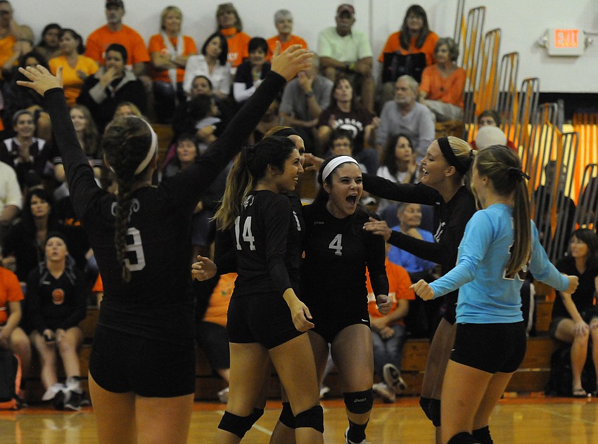 The Riverview High volleyball team celebrates a point during its 25-19 victory over Sarasota in the opening set.