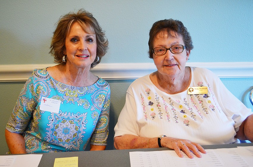 Helen Francis and Becky Westbrook helped sign members in for the cookout.