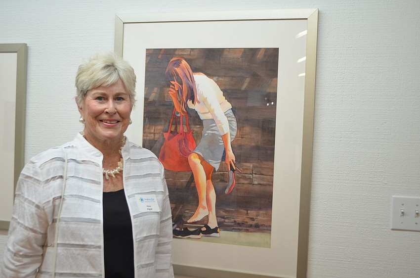 Anne Abgott poses in front of her watercolor â€œNY, NY.â€