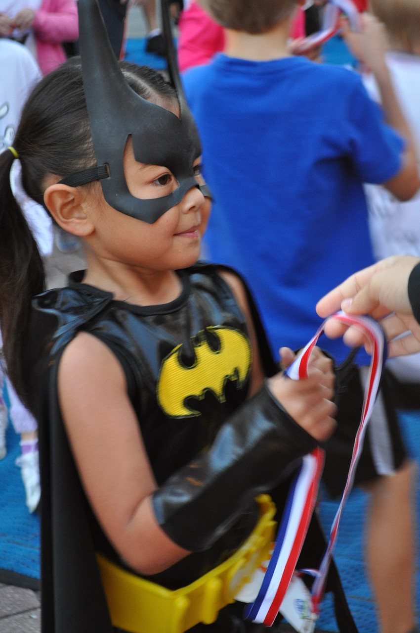 Aaryn Mason, 5, receives her post-run medal.