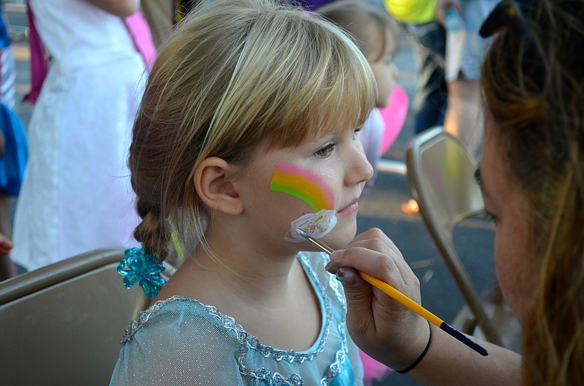 Emma Webb adds face paint as part of her costume.