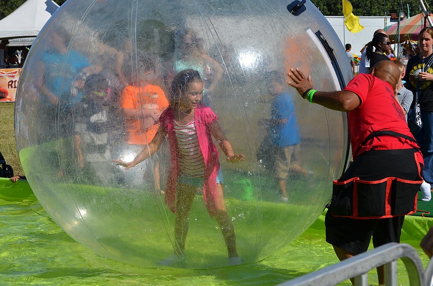 Molly Dillon takes a turn in the Walking Water Bubble ride.