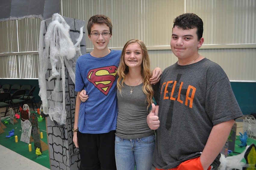 Spencer Waid, Hannah Brady and John Robinson check out the graveyard.