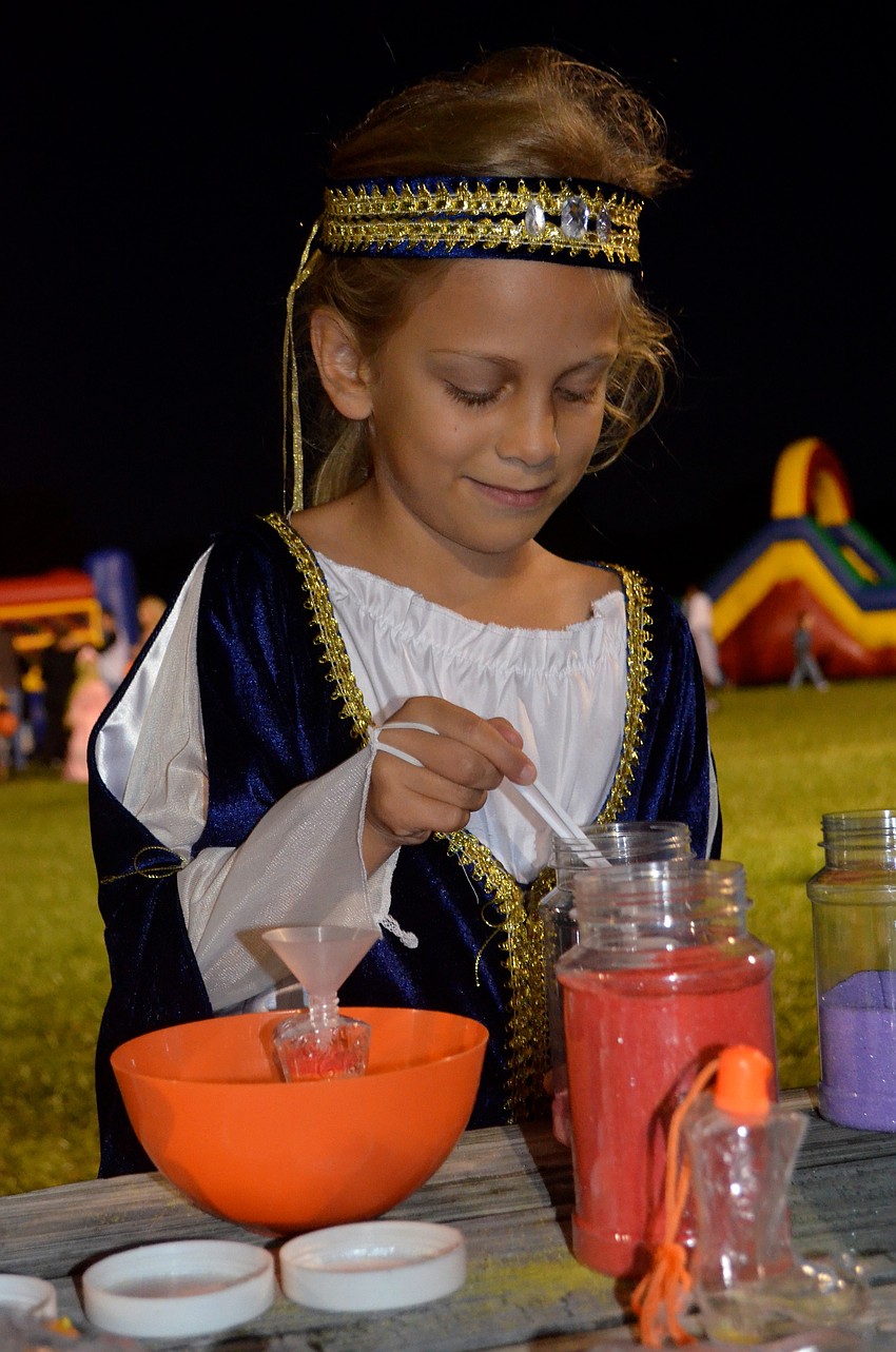 Lindsey Canna crafts a sand creation.