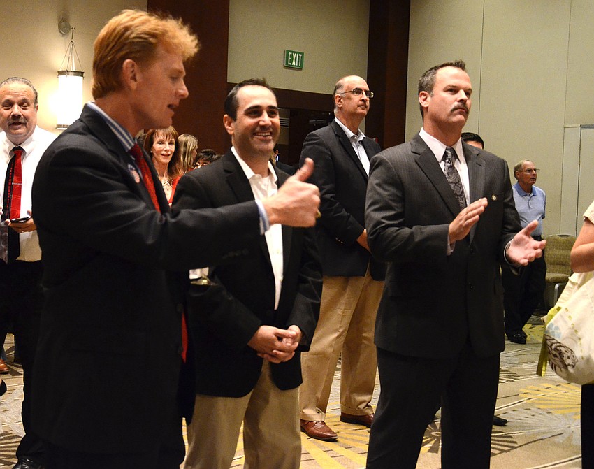Sarasota County Commission Chairman Charles Hines gives Paul Caragiulo a â€œthumbs upâ€ as a precinct update showed the District 2 candidate in the lead. Caragiulo won the county commission seat.