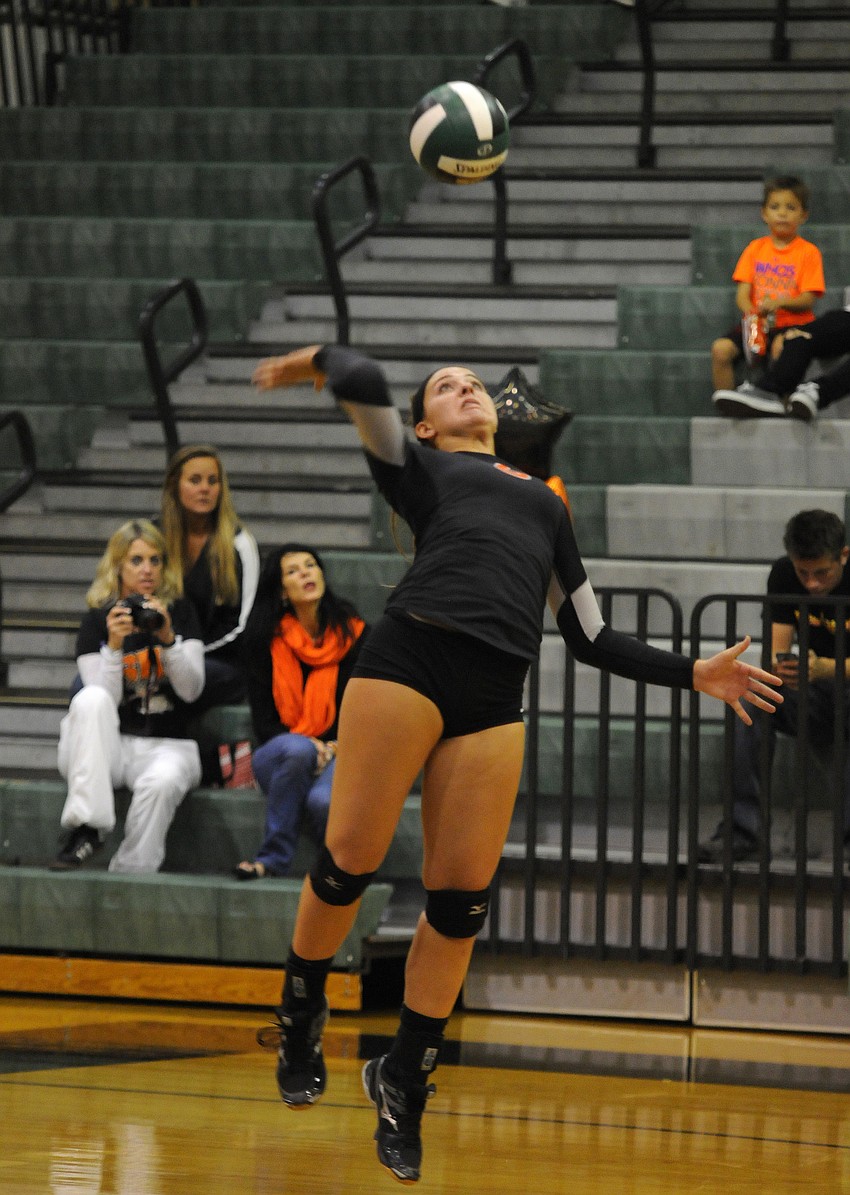 Sophomore middle blocker Anna Massey serves the ball for Sarasota during the first set.
