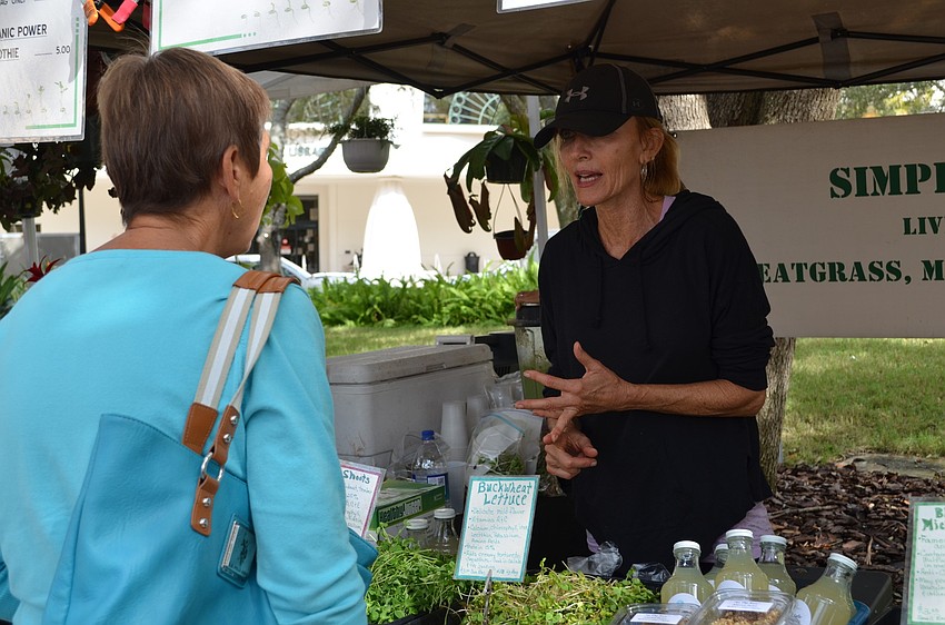 Jouan explains to a customer some of the ingredients from Simply Organix.