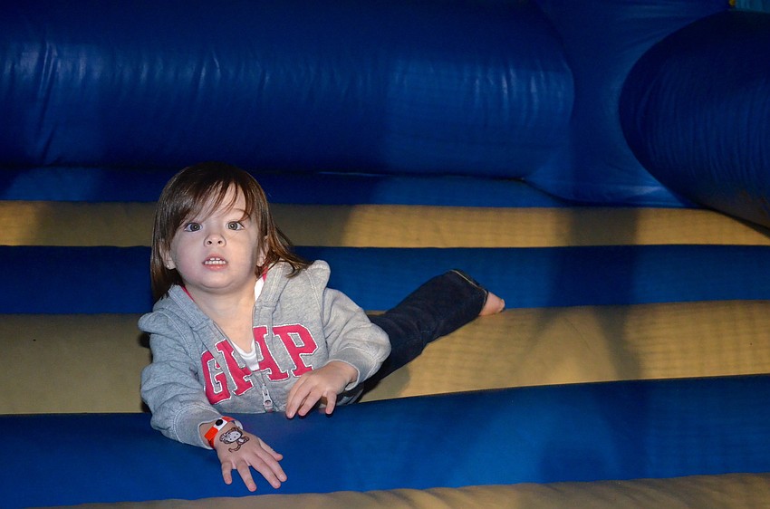 Two-year-old Tori O'Donnell plays around in the jump house.