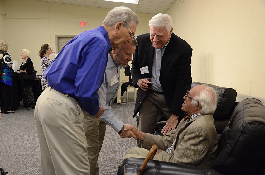 Ron Johnson and Scott Glaze talk with photographer Louis Cabot.