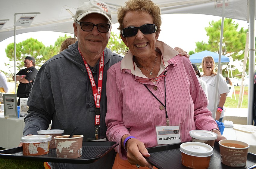 Arnie and Maureen Binderman fill their trays with soups to sample.