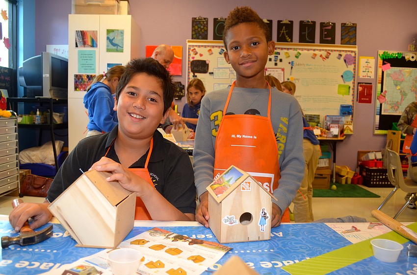 Friends Cliff McMurray and Josh Rutledge work together on their birdhouses.