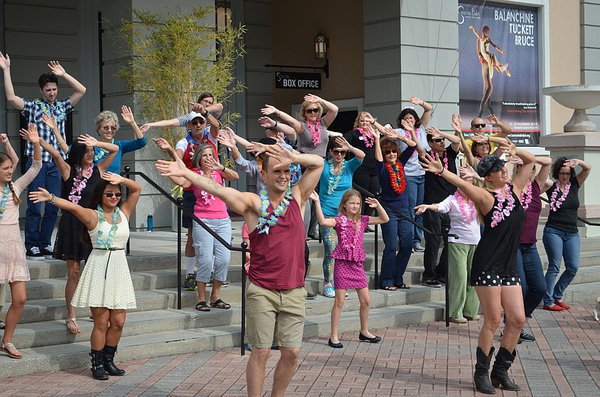 The music video dancers going through their steps.