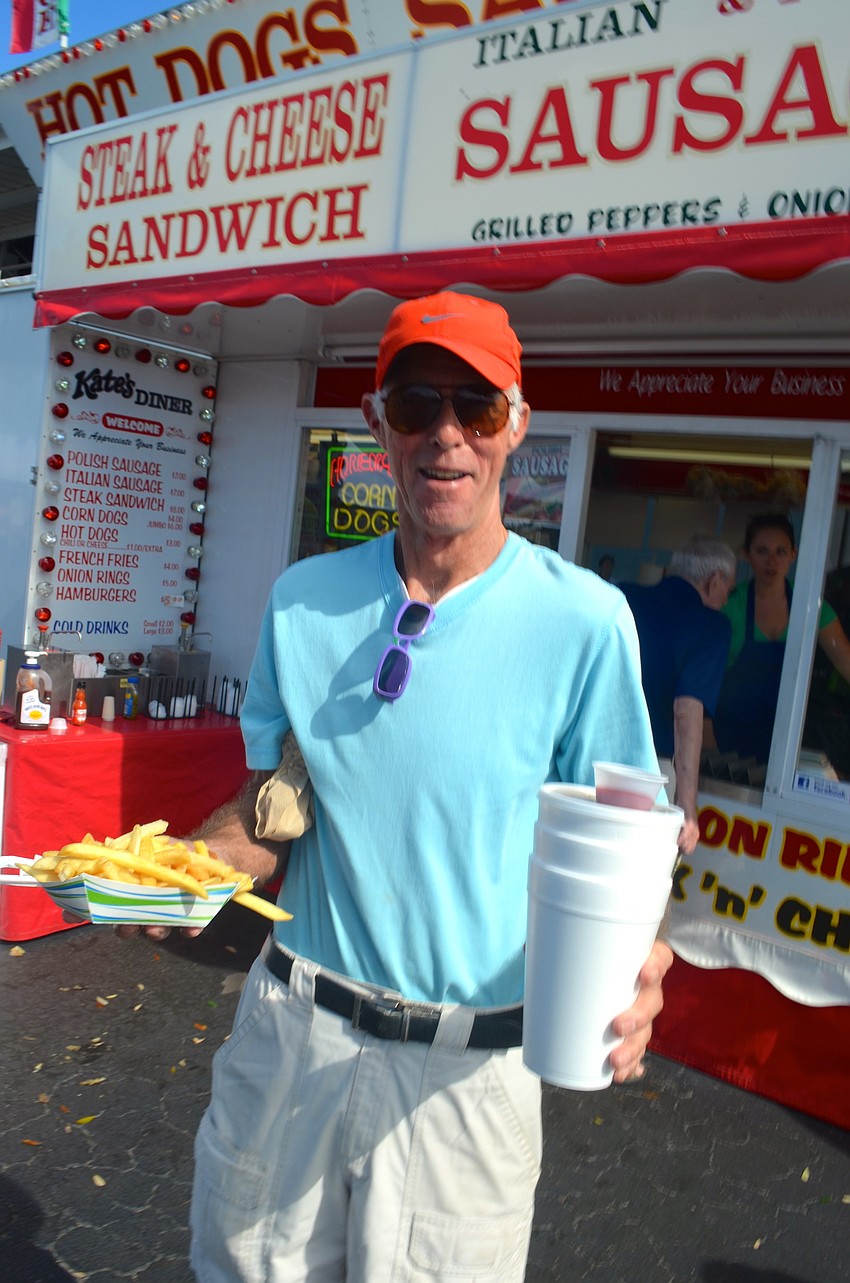 Dick Sleichter loads up on food and drinks.