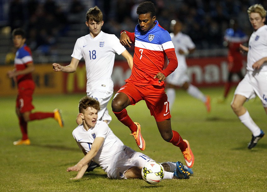 U.S. forward Haji Wright pushes the ball past an England defender in the first half.