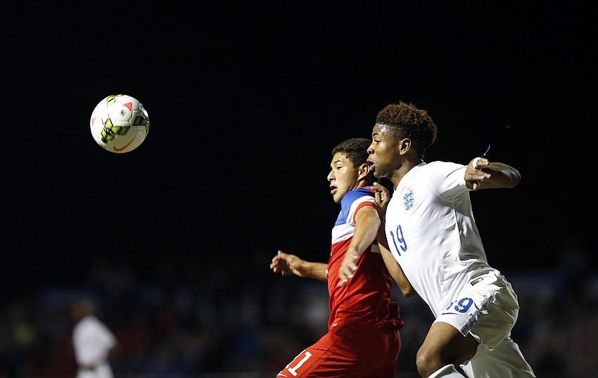U.S. forward Josh Perez attempts to gain possession away from Englandâ€™s Jahmal Hector-Ingram.