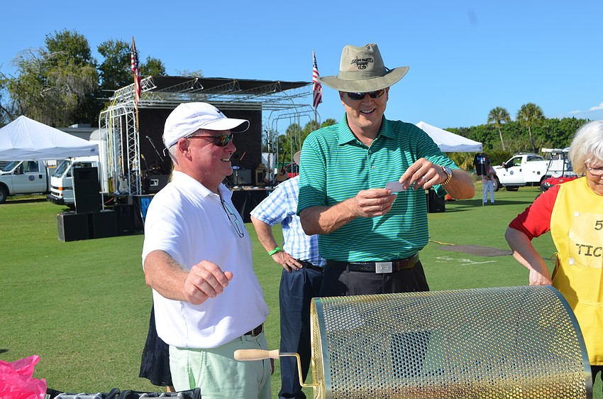 Congressman Vern Buchanan pulls out the raffleâ€™s winning ticket.