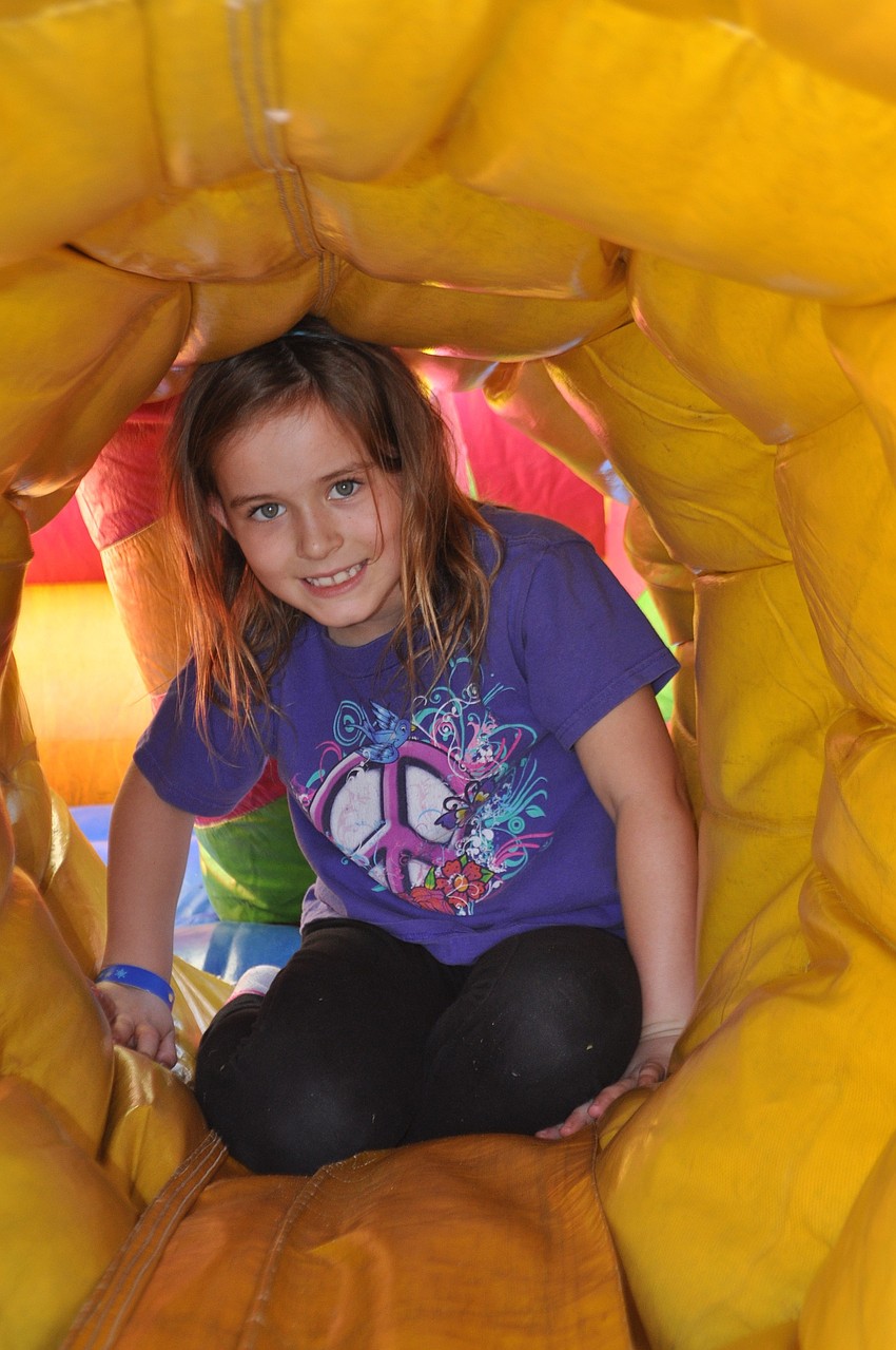 Maggie Sugalski, 7, makes her way through an inflatable obstacle.