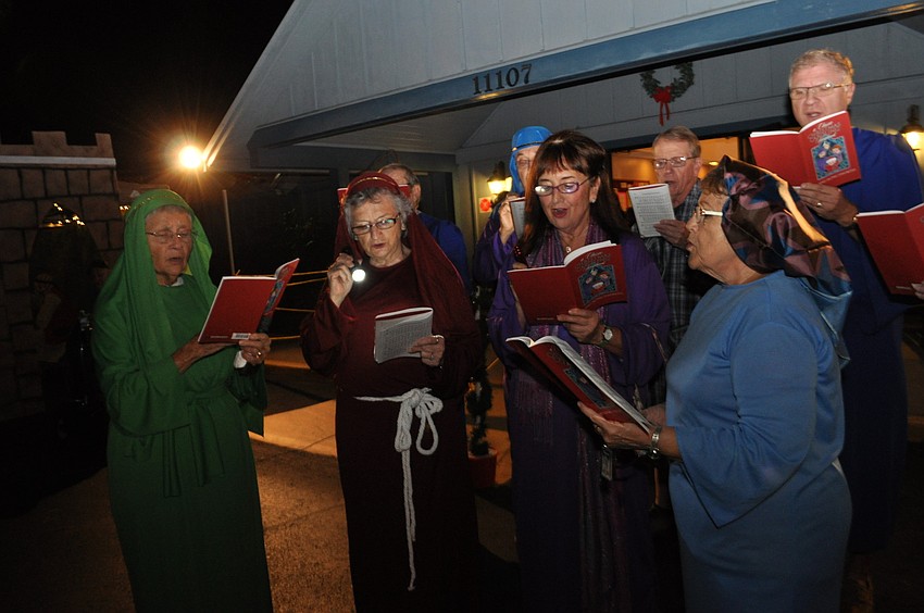 Carolers spread holiday cheer.