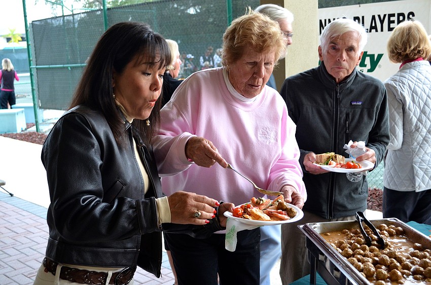 Sandra Ceshker anxiously waits for Dolores Levy to serve up the meatballs.