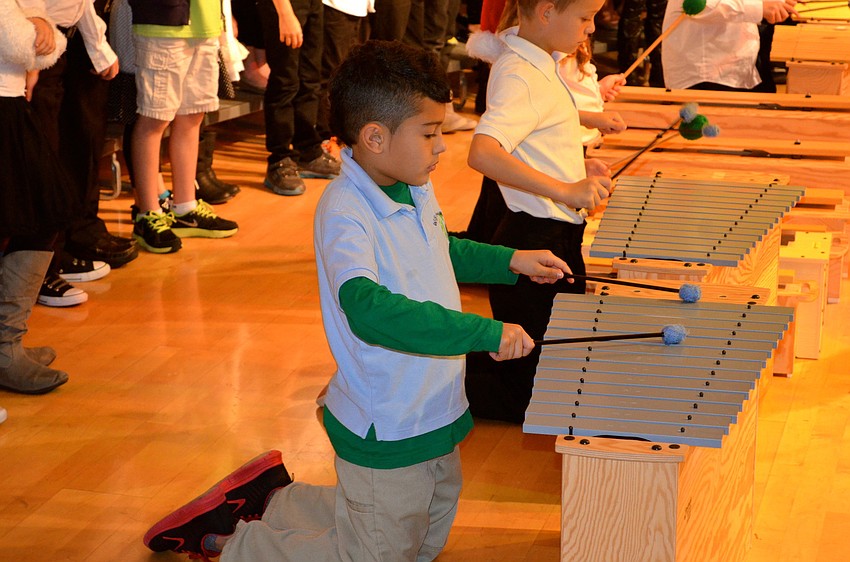 Gilbert Luviano focuses on playing his instrument.