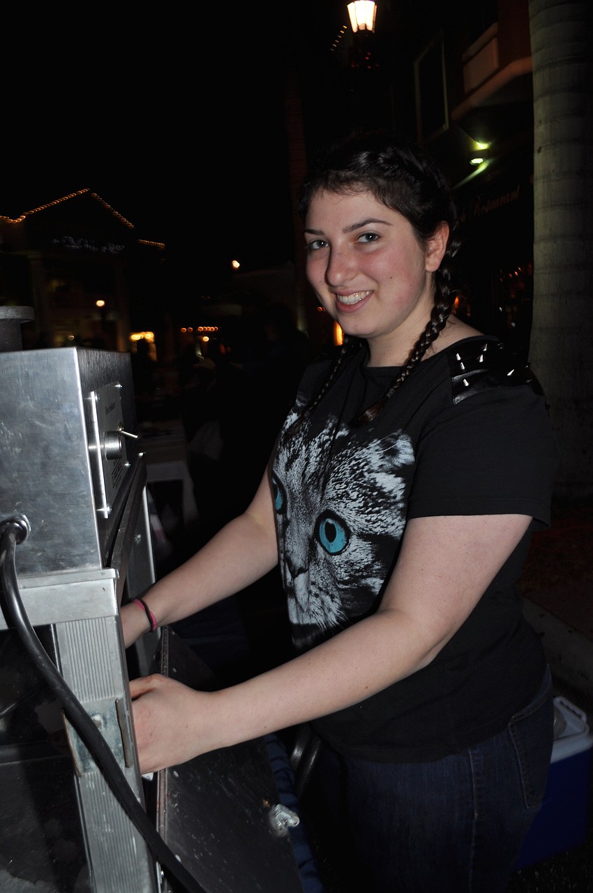 Sydney Wankoff makes snow cones with the help of friend, Melissa Gonyea, not pictured.