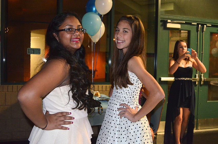 Friends Sabrah Sandho and Sofia Turasz take a break from dancing.