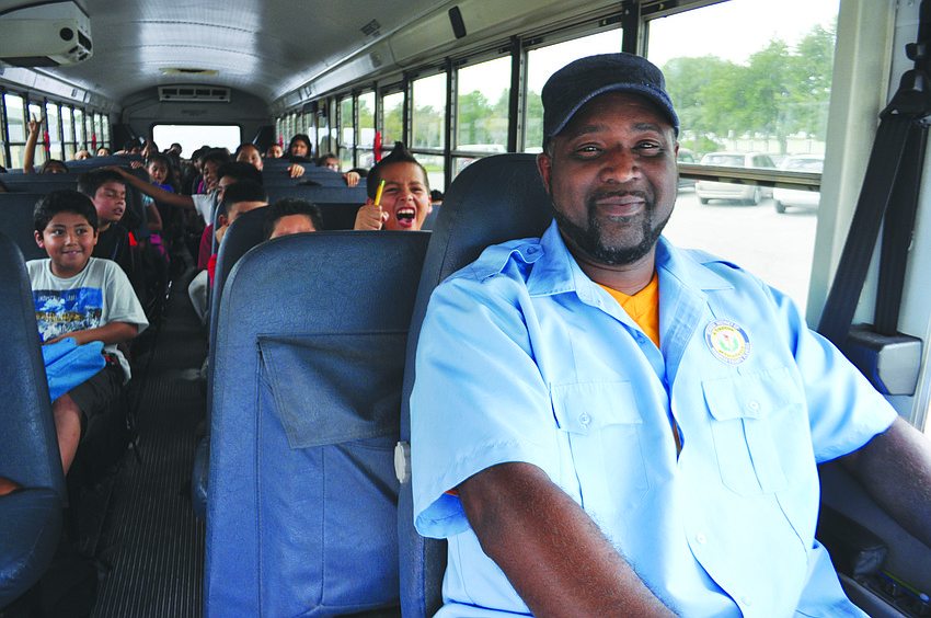 Mike McCarter drives off with his passengers from McNeal Elementary for the last time.