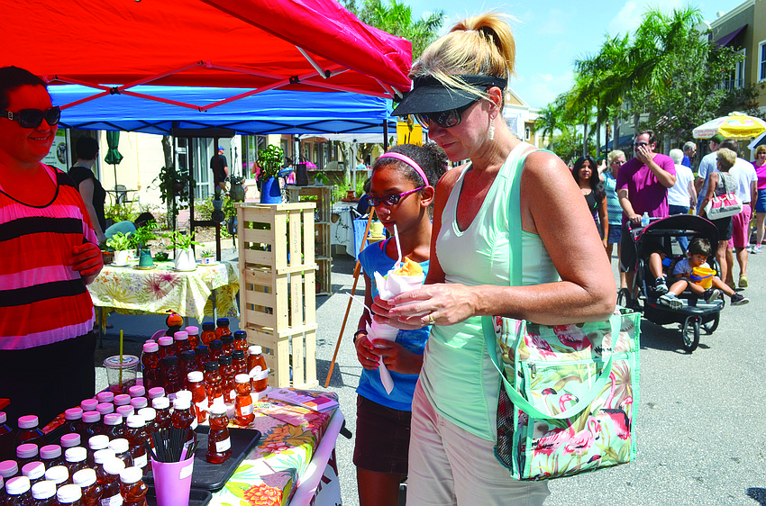 Sally Cestero and her daughter, Sara, decide which honey to purchase at the Lakewood Ranch Main Street Farmers Market.