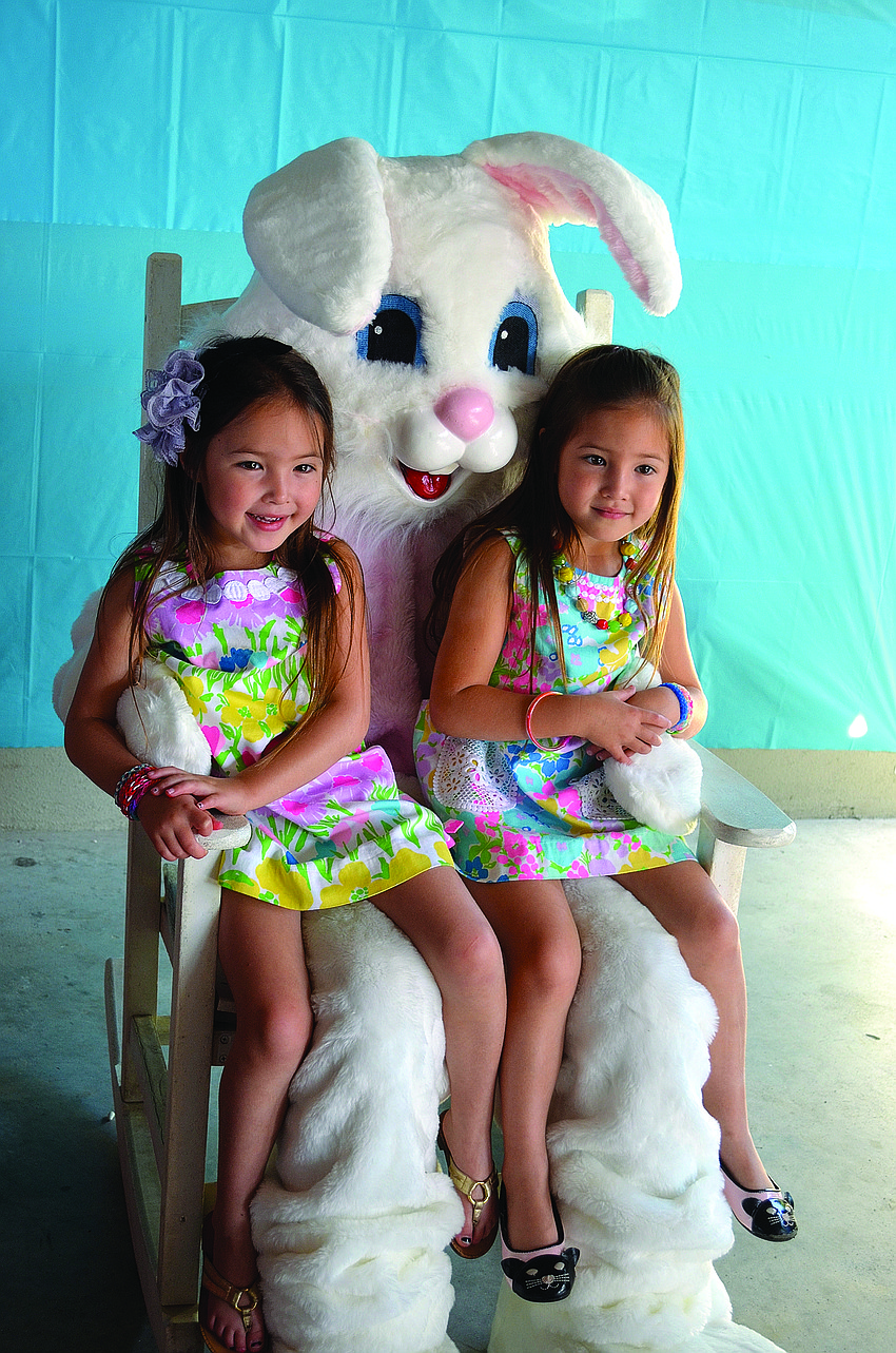 Five-year-old twins Aidan and Adelle Reed sit with the Easter Bunny.