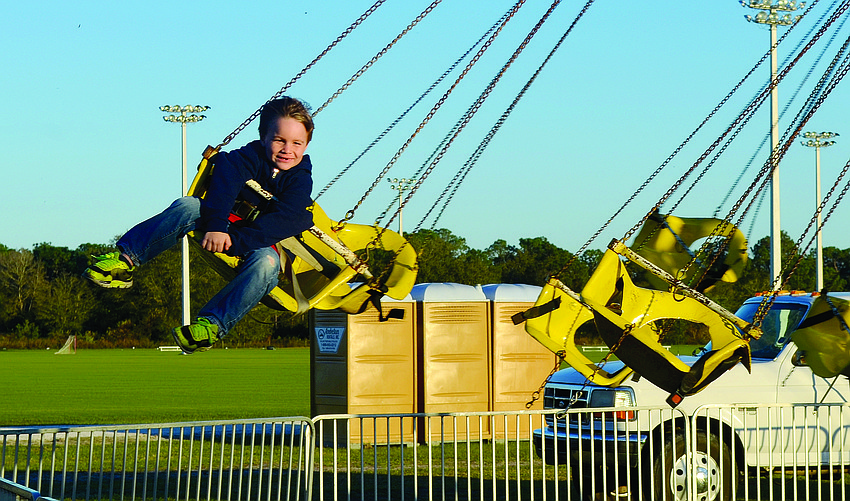 Cooper Leiberick, 5, soars on the swing ride alone at the Manatee County Fair.