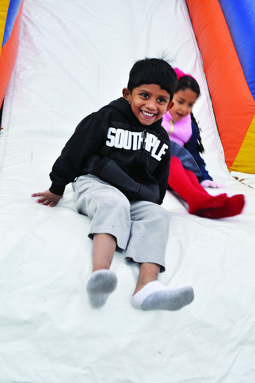 Samik Choudhury, 4, can't get enough of the slide during Tara Elementary School's winter carnival.