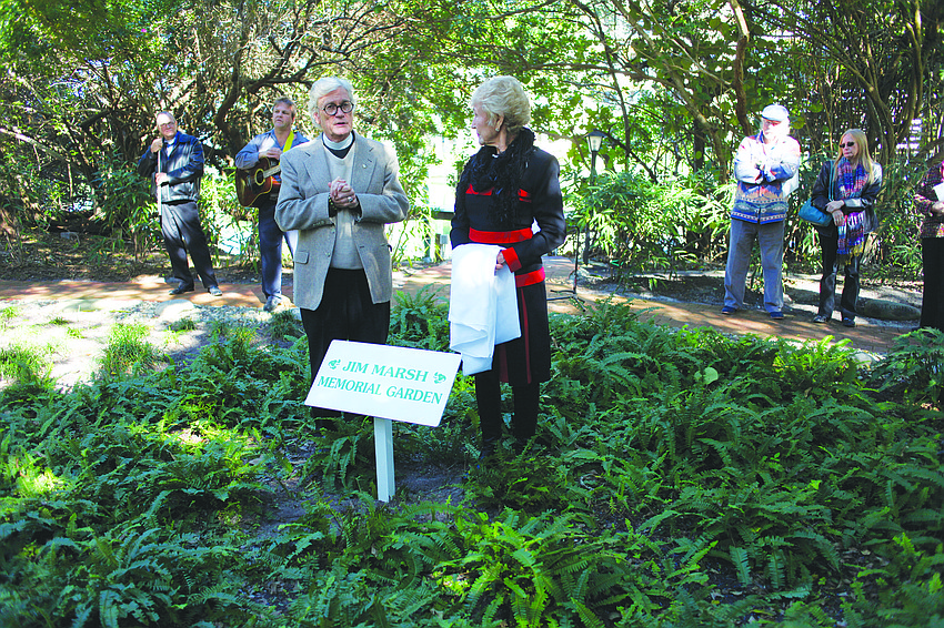 The Rev. Vincent Carroll and Claire Marsh unveil a sign that honors Marsh's late husband, the Rev. Jim Marsh during a Jan. 25 dedication ceremony at Longboat Island Chapelâ€™s memorial garden.