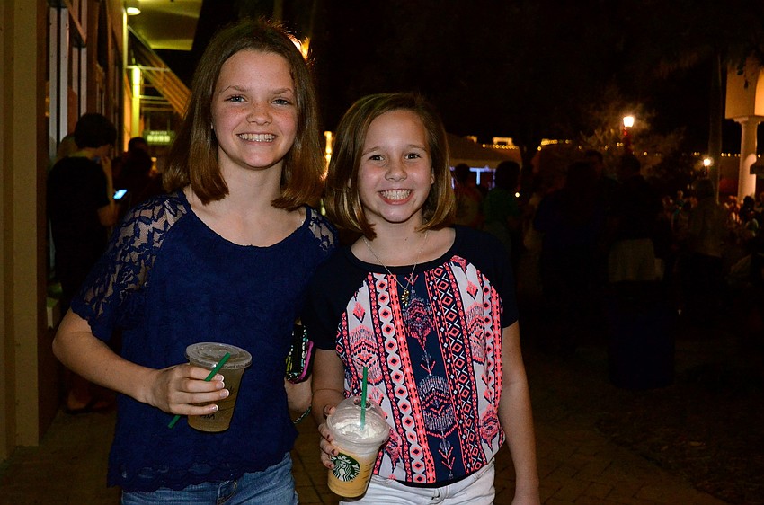 Maddy Kahler and Emery Perez sip on coffee drinks.