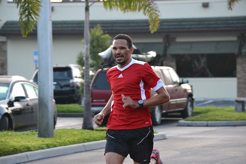 Johnnie Luvavali is the first to approach the finish line for the New Balance Fun Run.