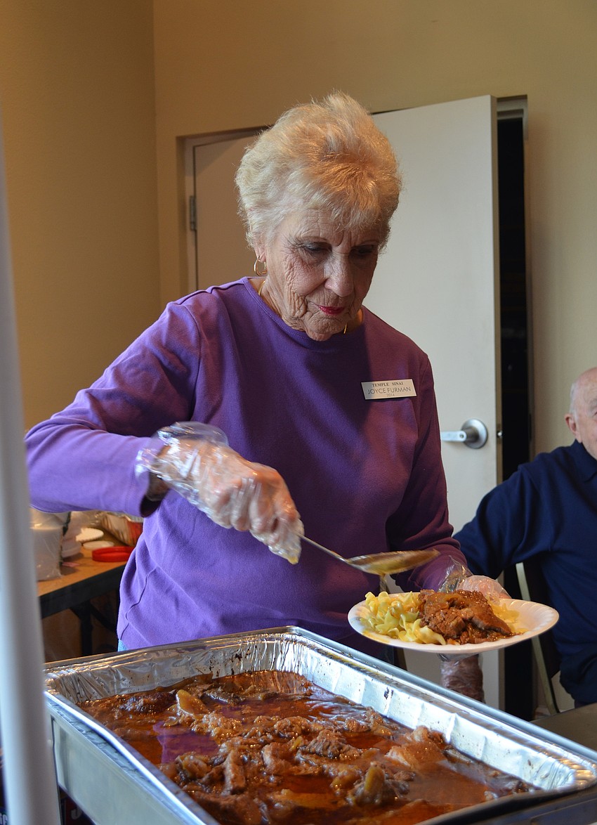 Joyce Furman serves beef brisket on egg noodles.