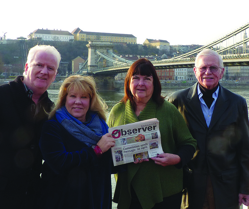 HUNGARY FOR NEWS. Anthony and Cheryl Hargaden and Pat and Bob Johnson read their Sarasota Observer in Budapest while enjoying the sights on a Danube River cruise.