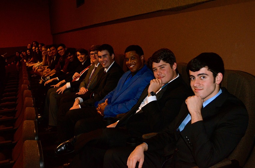 Aspiring filmmakers have fun in a theater before the presentations start.