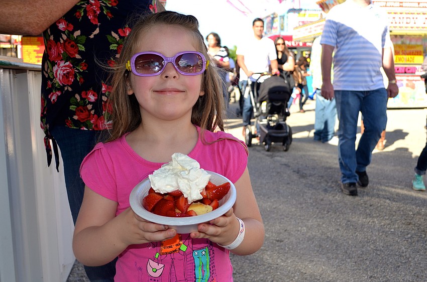 Olivia Gratzer shows off her strawberry sweet treat.