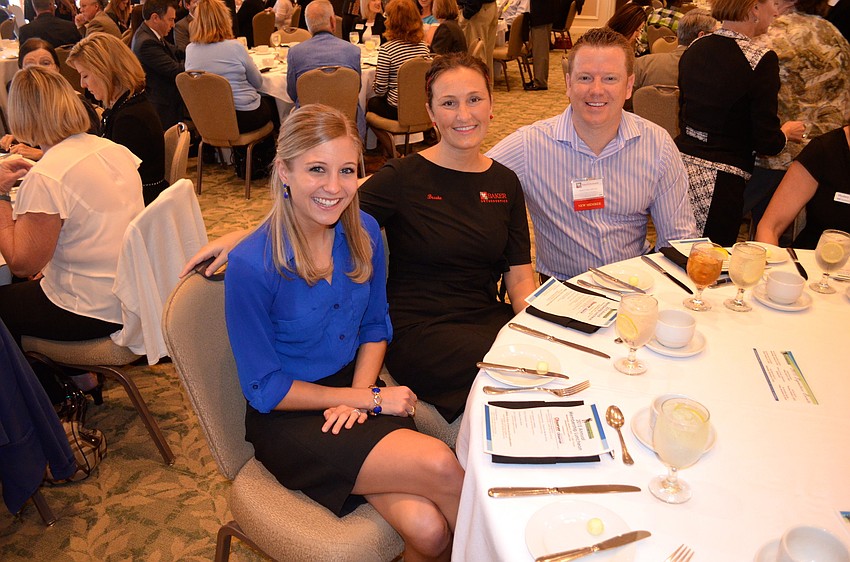 Courtney Grovatt enjoys a cold drink beside friends Brooke and Dr. Matt Baker.