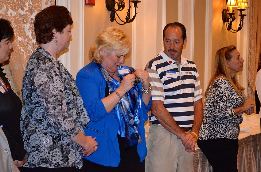 Maribeth Phillips fastens her new pin to her outfit.