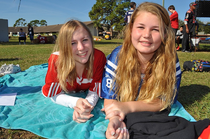 Lindsay Ashe and Amber Mangrune watch from the sidelines.