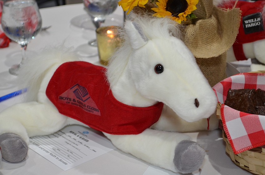 The cowboy theme was used throughout the event including the centerpieces with ponies and sunflowers.