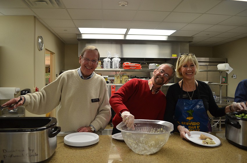Kent Capps, Jay Wallick and Lutie Uihlein serve dinner.
